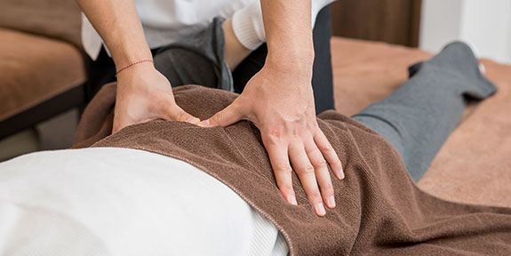 patient getting diversified chiropractic for auto accident injury in Sherman