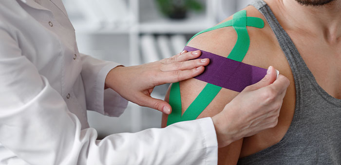patient receiving kinesio taping in Sherman for auto accident injury recovery